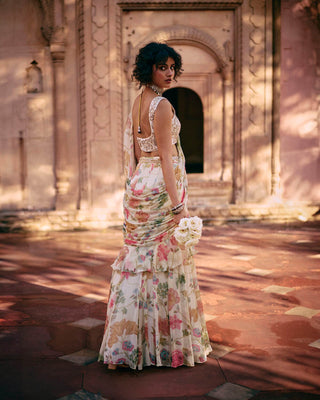 This exquisite, pre-draped saree is crafted from a light-as-air chiffon fabric and comes with an embroidered blouse. The chintz embroidered blouse is elevated with zari and aari work lending an effortless allure to this drape. Designed by Paulmi and Harsh