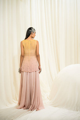 Model posing from the back to show the palazzo dress with top