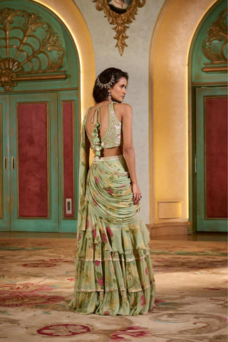 Back view showcasing the graceful fall of the printed chiffon saree with layered ruffles and the refined silhouette of the embroidered blouse.