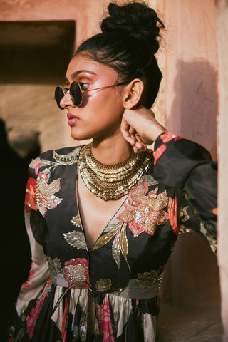 Handcrafted floral habutai silk peplum with intricate pearl and zardosi detailing and tassel accents, styled with a solid black pre-draped skirt for bold elegance.