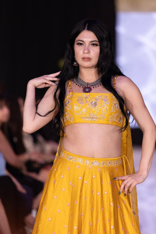 Yellow haldi lehenga set with pink, jari embroidery by Paulmi & Harsh, perfect for a bride’s Haldi ceremony and wedding celebrations.