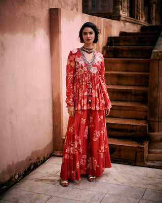 The Paulmi and Harsh signature peplum featuring Roop flip bird print. The yoke and sleeves are hand-embroidered and the peplum has drawstring detailing with delicate tassels. It is paired with printed palazzos. Perfect outfit for cocktail and special occasion.
