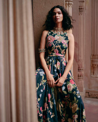 An elegant jumpsuit designed by Paulmi and harsh. floral print all-over, it features a flowy bottom and halter neckline. The yoke is hand-embroidered in zardozi and sequins. The look is complete with a printed belt. Perfect one piece dress for wedding, parties, cocktail, special occasions.