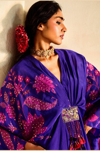 Detailed close-up of hand-embroidered sequins, printed motifs, and silk organza texture with net patch accents.