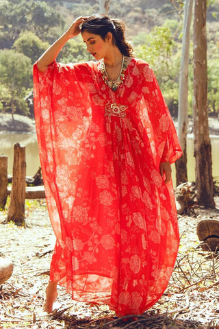 A vibrant red and red chintz print kaftan with a handcrafted embroidered patch at the center, styled for casual days, festive gatherings, or relaxed resort wear. Designed by Paulmi and Harsh.