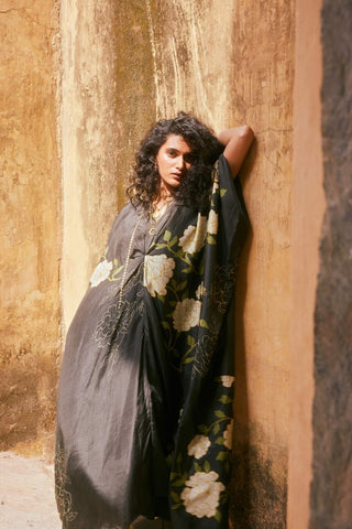 Flowy floral habutai silk kaftan with knot accents and black slip, a chic boho outfit for travel and leisure.