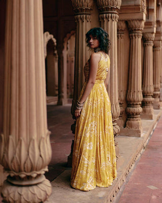 A Tuscany yellow flared jumpsuit featuring Roop flip bird print. The print is enhanced with hand-embroidery in zardozi and aari work.  Designed by Paulmi and Harsh. Perfect outfit for cocktail, wedding, parties and special occasion for bride or wedding guests.