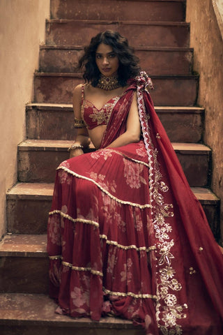 A vintage floral printed chiffon pre–draped saree with hand–embroidered lace detailing. It is paired with a bralette style floral print hand-embroidered blouse. Designed by Paulmi and Harsh.