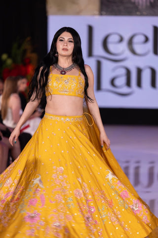 Yellow haldi lehenga set with pink, jari embroidery by Paulmi & Harsh, perfect for a bride’s Haldi ceremony and wedding celebrations.