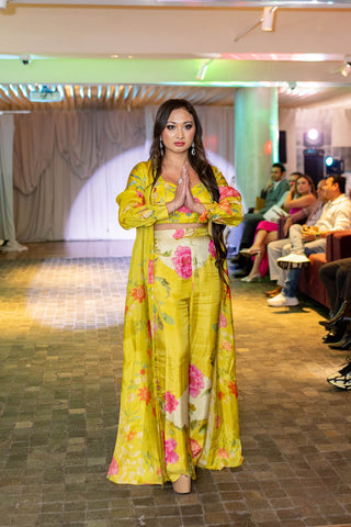 Model posing in Paulmi and Harsh lime yellow jacket set a statment attire at Australian fashion Grandeur Show.