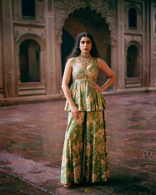 Green maeve peplum featuring Paulmi And Harsh signature Roop flip bird print. The yoke and back are hand-embroidered. It is paired with printed flared palazzos. Indian ethnic women's wear perfect for parties, wedding, events, cocktail.