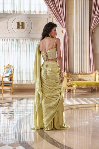 Luxury festive saree set with a structured corset blouse and satin drape, combining traditional zardozi craftsmanship with modern elegance.