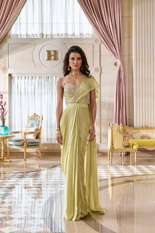 Mint green corset-style blouse crafted in lustrous silver jacquard, fully embellished with intricate zardozi embroidery, paired with a luxurious satin pre-draped saree, perfect for cocktail parties, wedding receptions and bridal festivities. Designed by Paulmi and Harsh