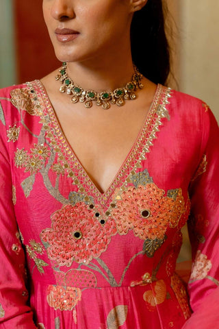 Close up of elegant pink floral V-neck Anarkali with heavy handcrafted embellishments and a net hand-embroidered dupatta, ideal for engagements and reception events.
