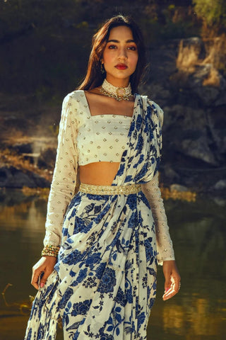 Modern pre-draped saree with indigo bird print and embroidered belt ideal for festive celebrations, wedding, parties and cultural gatherings. Designed by Paulmi and Harsh.