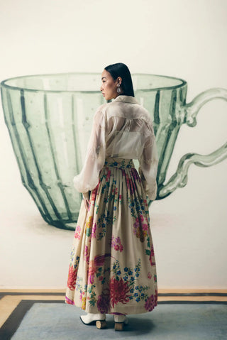 Back look of women's Alora off white designer skirt set pairs a relaxed embroidered organza shirt with a floral printed fitted-waist skirt, offering a refined look for festive celebrations and events.