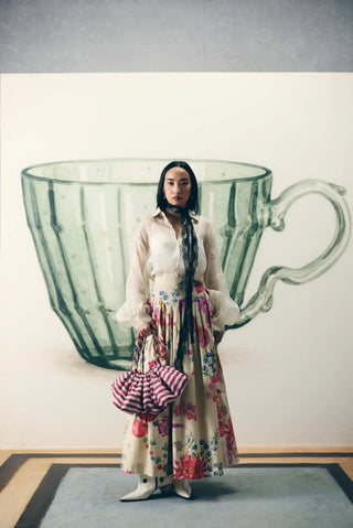 Elegant Alora off white embroidered shirt and floral printed skirt set combines delicate detailing with a flattering fitted waist, making it ideal for festive parties and celebrations. A chic designer outfit for cocktail parties and soiree.