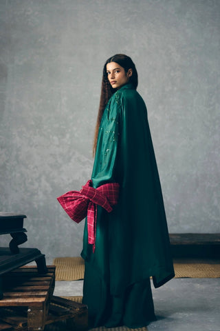 Back look of Wasabi green designer jumpsuit showcases a relaxed silhouette layered with an embroidered organza jacket, offering a polished luxury look for festive gatherings and special occasions.