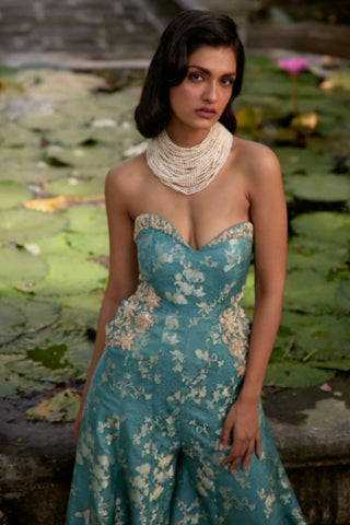 Contemporary blue strapless jumpsuit crafted in self-woven jacquard fabric with intricate embroidered floral detailing.