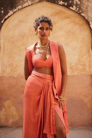 Paulmi and Harsh designed, a chic coral jacket and blouse crafted from linen paired with a silk organza skirt. The jacket is designed with cutwork detailing using our floral motifs. The skirt comes with pre–stitched wrap detailing and is fully lined.