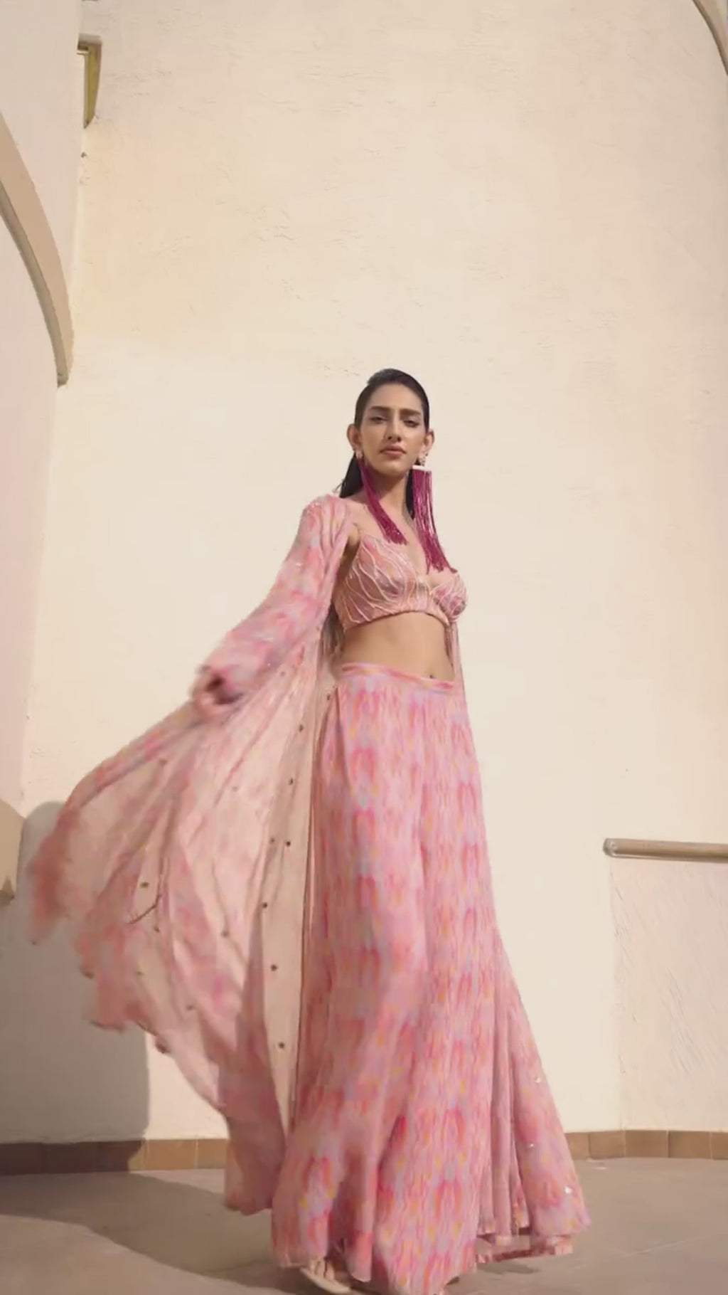 Contemporary abstract printed palazzo set paired with an intricately embroidered blouse and stylish jacket, perfect for festive gatherings and statement occasions at Leela Lane. Designed by Ease.