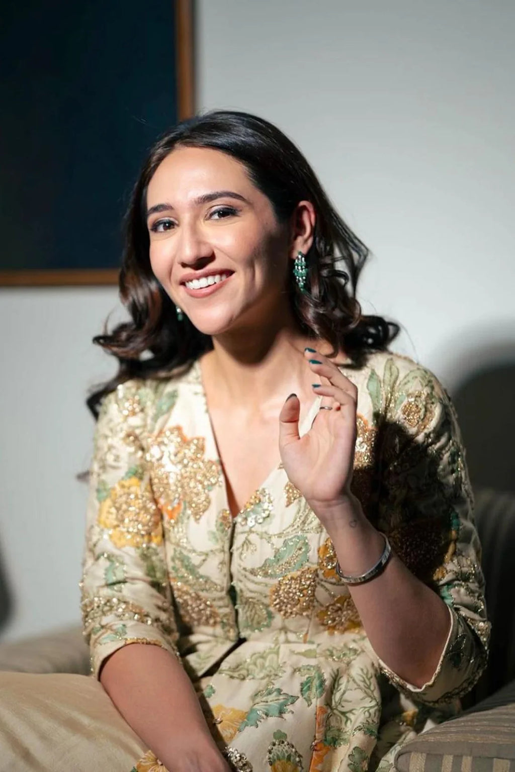 A printed peplum, featuring delicate hand-embroidery on yellow and orange floral print. It is paired with a pre-draped skirt. Perfect for bridal looks, pre-wedding events, wedding guest glam and unforgettable special occasions.