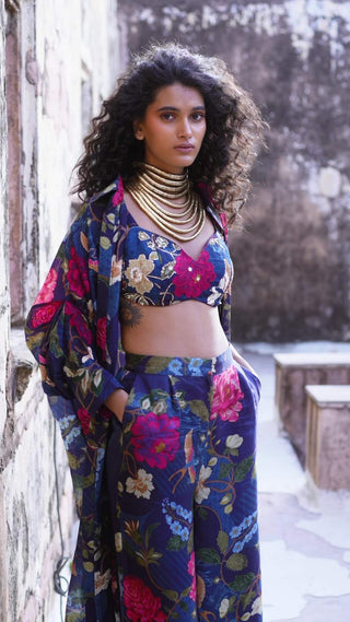 Women posing for photoshoot in Blue floral printed jacket set with crop top and pants with side pockets, designed by Paulmi and Harsh. Perfect dress for parties, brunch, pubbing, formal or casual outing with friends.
