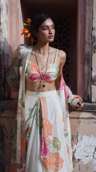Model posing in Paulmi and Harsh ivory floral print Jacket set with crop top and skirt for photoshoot. A perfect women's dress for party, beach party, resort vacation, event, celebration for summer or spring. 