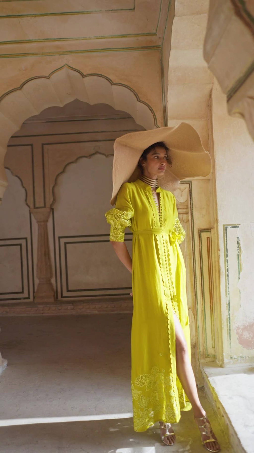 Model in fresh lime yellow cutwork long sleeves maxi dress with belt and center slit designed by Paulmi and Harsh. An indo-western chic women's dress for casual outing or parties, summer, vacation, events, special occasions.