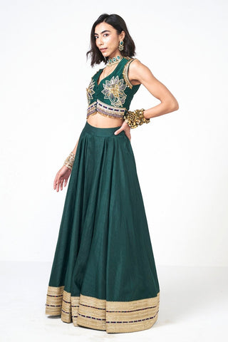 Elegant bottle green Dupion Jalsa Lehenga Set by Rishi and Vibhuti showcasing handcrafted embroidery with scattered sequins. Featuring a matching skirt and blouse, this luxurious designer ensemble is perfect for festive occasions, wedding functions, and celebration wear.