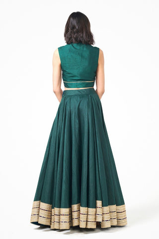 Back look of legant bottle green Dupion Jalsa Lehenga Set. Featuring a matching skirt and blouse, this luxurious designer ensemble is perfect for festive occasions, wedding functions, and celebration wear.