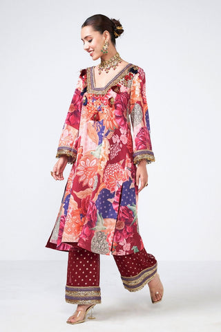 Premium Cherry Choga Set in cola color showcasing detailed appliqué craftsmanship with scattered curves, coin accents, and tassel embellishments. This stylish kurta and pants ensemble is perfect for festive events, receptions, and designer ethnic wear.
