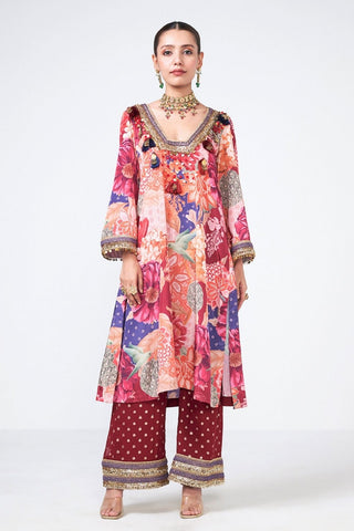 Designer Cherry Choga kurta and pants set crafted from premium crepe and georgette in a rich cola shade. Enhanced with appliqué work, scattered curves, decorative coins, and tassel detailing for a graceful festive and occasion wear look.
