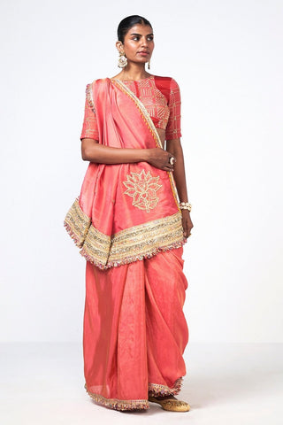 Luxury Coral Tales Saree by Rishi and Vibhuti crafted in lightweight organza and tissue with floral embroidery, ornate gold embroidered border and tassel accents. Premium women's ethnic wear with embellished blouse for festive, wedding and party styling.