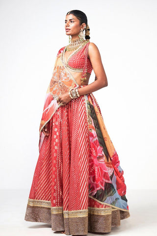 Gulbahar Lehenga Set in coral Chanderi and organza featuring exquisite appliqué work. This elegant three-piece designer ensemble includes a lehenga, blouse, and dupatta, making it ideal for weddings, festive celebrations, receptions, and traditional special occasions.