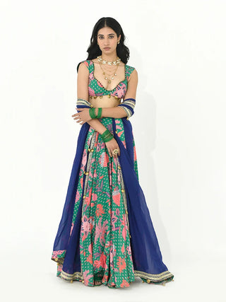 Model in jade green boho lehenga set crafted in crepe and organza fabric featuring intricate needlework, decorative trims, tassels, blouse, lehenga, and dupatta. Designed by Rishi and Vibhuti.