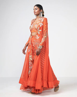 Side profile showing the cape, blouse, and pants of the orange Dhadak Set.