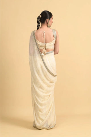 Designer ivory saree, Georgette & Chanderi Silk fabric, Linear trim golden embroidery on the border of the saree. 