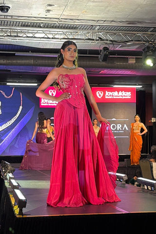 Model in fuchsia pink crepe corset lehenga set with fit-and-flare silhouette by Rishi and Vibhuti.