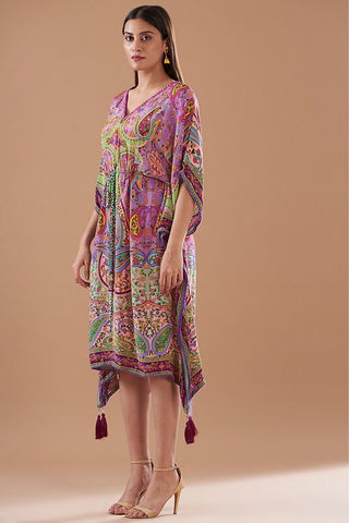 A richly patterned purple kaftan decorated with bold paisley motifs and vibrant contrasting prints, styled in a loose, airy silhouette ideal for summer outings or holiday vacations.
